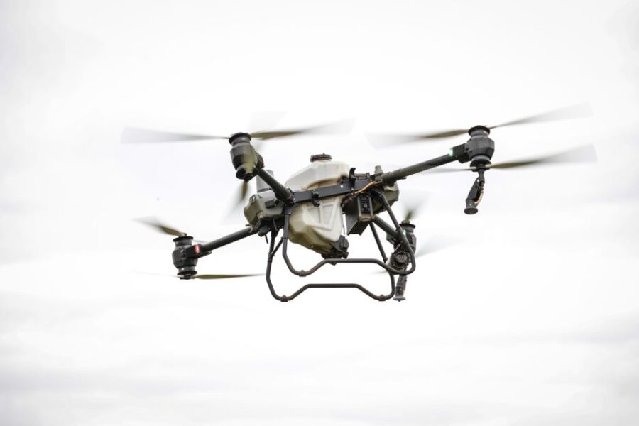 A drone flying over a rugged landscape, capturing data for geological surveys and inspections.
