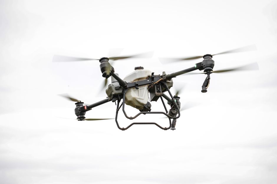 A drone flying over a rugged landscape, capturing data for geological surveys and inspections.